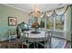 Charming dining room with a chandelier, large window with curtains, and vintage-style furniture at 803 S Main St, Summerville, SC 29483