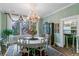 Elegant dining room featuring a chandelier, traditional decor, and a large window with decorative curtains at 803 S Main St, Summerville, SC 29483