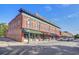 A street view in Summerville, SC showcasing a block of historic shops with awnings and street parking at 803 S Main St, Summerville, SC 29483