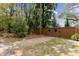 Gravel driveway and decorative gate surrounded by trees and shrubs at 803 S Main St, Summerville, SC 29483