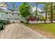 Charming home with a well-manicured lawn, blooming azaleas, and a convenient two-car garage at 803 S Main St, Summerville, SC 29483