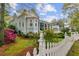 Charming two-story home with landscaped yard and white picket fence at 803 S Main St, Summerville, SC 29483