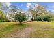 Charming two-story home featuring light blue siding, a well-manicured lawn, and mature trees creating a serene setting at 803 S Main St, Summerville, SC 29483