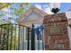 Property number on a brick column next to the metal entry gate of a charming light blue home at 803 S Main St, Summerville, SC 29483