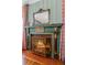 Ornate fireplace with decorative accents and a vintage-style fire screen at 803 S Main St, Summerville, SC 29483