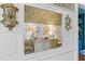 Foyer mirror reflecting hardwood floors, designer wallpaper, and stylish furnishings, enhancing the entry's elegance at 803 S Main St, Summerville, SC 29483