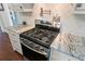 Modern stainless steel gas cooktop with marble countertops in the kitchen at 803 S Main St, Summerville, SC 29483