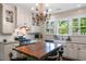 Bright kitchen features custom white cabinets, large central island at 803 S Main St, Summerville, SC 29483