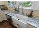 Close up of the kitchen sink area featuring bright window, new faucet, and marble countertops at 803 S Main St, Summerville, SC 29483