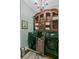Laundry room featuring modern washer and dryer units, and custom-built wooden storage cabinets at 803 S Main St, Summerville, SC 29483