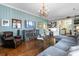 Elegant living room with hardwood floors, chandelier, and comfortable seating at 803 S Main St, Summerville, SC 29483