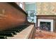 Living room with an upright piano, a fireplace, and a patterned rug at 803 S Main St, Summerville, SC 29483