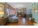 Bright living room featuring a fireplace, hardwood floors, and a comfortable gray sectional at 803 S Main St, Summerville, SC 29483