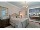 Spacious main bedroom with a chandelier, ensuite bath, and classic decor at 803 S Main St, Summerville, SC 29483