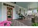 Charming front porch with ample seating, decorative plants, and a porch swing, creating a welcoming outdoor space at 803 S Main St, Summerville, SC 29483