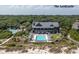 Aerial view of a building with outdoor pool with many people and lush green forest at 83 Blue Heron Pond Rd, Kiawah Island, SC 29455
