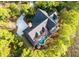 Aerial view of a home with a pool amid lush greenery at 83 Blue Heron Pond Rd, Kiawah Island, SC 29455