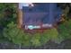 Aerial view of a beautiful home with a pool nestled among lush trees at 83 Blue Heron Pond Rd, Kiawah Island, SC 29455