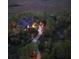 Aerial view of a wooded estate with a charming home and boardwalk at twilight at 83 Blue Heron Pond Rd, Kiawah Island, SC 29455