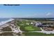 Aerial view of a beautifully landscaped golf course alongside the ocean with blue skies at 83 Blue Heron Pond Rd, Kiawah Island, SC 29455