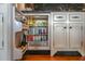 Bar area features a fully stocked mini refrigerator with storage, marble countertops, and stylish cabinetry at 83 Blue Heron Pond Rd, Kiawah Island, SC 29455