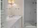 Bright bathroom featuring marble countertops, white walls and trim, and a glass-enclosed shower at 83 Blue Heron Pond Rd, Kiawah Island, SC 29455