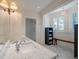 Bright bathroom featuring marble countertops, white walls and trim, and a glass enclosed shower at 83 Blue Heron Pond Rd, Kiawah Island, SC 29455