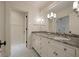 Elegant bathroom with double vanity, granite countertop, and framed mirror with modern light fixtures at 83 Blue Heron Pond Rd, Kiawah Island, SC 29455