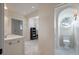 Bright bathroom with marble floors, white walls, and a circular window to the side of the toilet at 83 Blue Heron Pond Rd, Kiawah Island, SC 29455