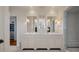 Bright bathroom featuring a double vanity, marble countertops, and a glass-enclosed shower with white subway tile at 83 Blue Heron Pond Rd, Kiawah Island, SC 29455