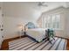 Bedroom with a bed with a blue patterned headboard, a ceiling fan, and hardwood floors at 83 Blue Heron Pond Rd, Kiawah Island, SC 29455