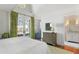 Bright primary bedroom featuring wood floors, high ceilings, and en suite bathroom at 83 Blue Heron Pond Rd, Kiawah Island, SC 29455