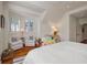 Bright bedroom featuring hardwood floors, tongue and groove ceiling, and a cozy window nook with seating at 83 Blue Heron Pond Rd, Kiawah Island, SC 29455