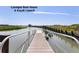 View of the Cassique Boat House dock extending over the water with a view of the surrounding area at 83 Blue Heron Pond Rd, Kiawah Island, SC 29455