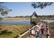 View of a marsh-front cabin on stilts with a long private dock at 83 Blue Heron Pond Rd, Kiawah Island, SC 29455