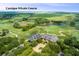 A captivating aerial view of the Cassique private course with immaculate greens and mature landscaping at 83 Blue Heron Pond Rd, Kiawah Island, SC 29455