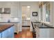 Eat-in kitchen area featuring a breakfast bar, white cabinets, and wood floors at 83 Blue Heron Pond Rd, Kiawah Island, SC 29455