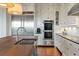 A gourmet kitchen featuring stainless steel appliances, white cabinets, and wood countertops at 83 Blue Heron Pond Rd, Kiawah Island, SC 29455