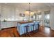 Bright, airy kitchen featuring a large island with seating, white cabinets, and modern stainless steel appliances at 83 Blue Heron Pond Rd, Kiawah Island, SC 29455