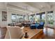 Spacious living room with ample natural light, comfortable seating, and views of the surrounding landscape at 83 Blue Heron Pond Rd, Kiawah Island, SC 29455
