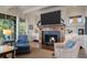 Cozy living room with a fireplace, comfortable seating, and views of the outdoors through large windows at 83 Blue Heron Pond Rd, Kiawah Island, SC 29455