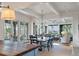 Open-concept living space featuring dining area and living room with large windows offering scenic outdoor views at 83 Blue Heron Pond Rd, Kiawah Island, SC 29455