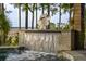 A close up shot of a water feature cascading down into a sparkling pool and spa at 83 Blue Heron Pond Rd, Kiawah Island, SC 29455