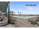 Lounge chairs surround a relaxing pool with palm trees and a view of the ocean at 83 Blue Heron Pond Rd, Kiawah Island, SC 29455