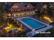 An inviting pool area at night with ample seating, umbrellas, and lit landscaping at 83 Blue Heron Pond Rd, Kiawah Island, SC 29455