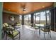 Comfortable screened-in porch with ceiling fan, wood ceiling and trim, and picturesque views of nature at 83 Blue Heron Pond Rd, Kiawah Island, SC 29455