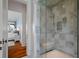 Modern tiled walk-in shower with a built-in bench and convenient shelving niche at 83 Blue Heron Pond Rd, Kiawah Island, SC 29455