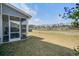 Backyard view from screened porch overlooking grassy lawn and pond at 832 Descartes St, Summerville, SC 29486