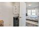 Modern bathroom with white tiled shower and open doorway to cozy bedroom at 832 Descartes St, Summerville, SC 29486