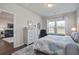 Bright bedroom with view, dresser with decor and mirror, a leather chair, and blue duvet at 832 Descartes St, Summerville, SC 29486